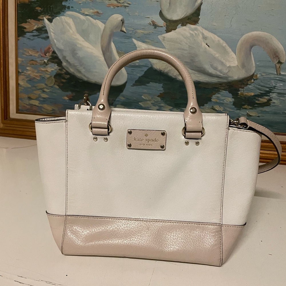 Kate Spade cream and beige purse with handles and crossbody strap.